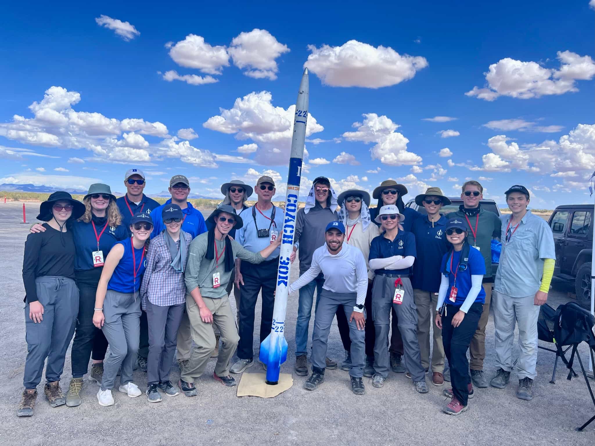 team photo with rocket in the desert