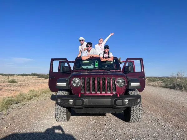 Cole, Chris, Allison, and Vinessa on top of a Jeep.